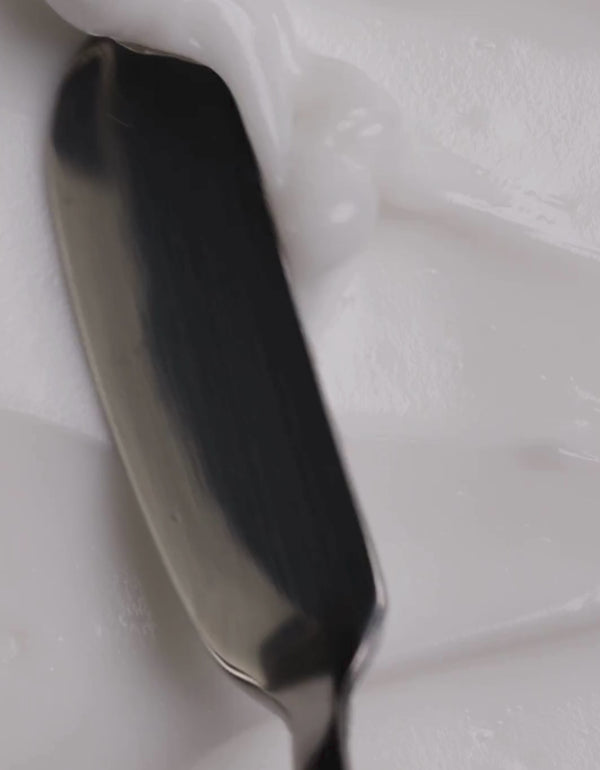 Closeup video of lotion texture with silver palette knife